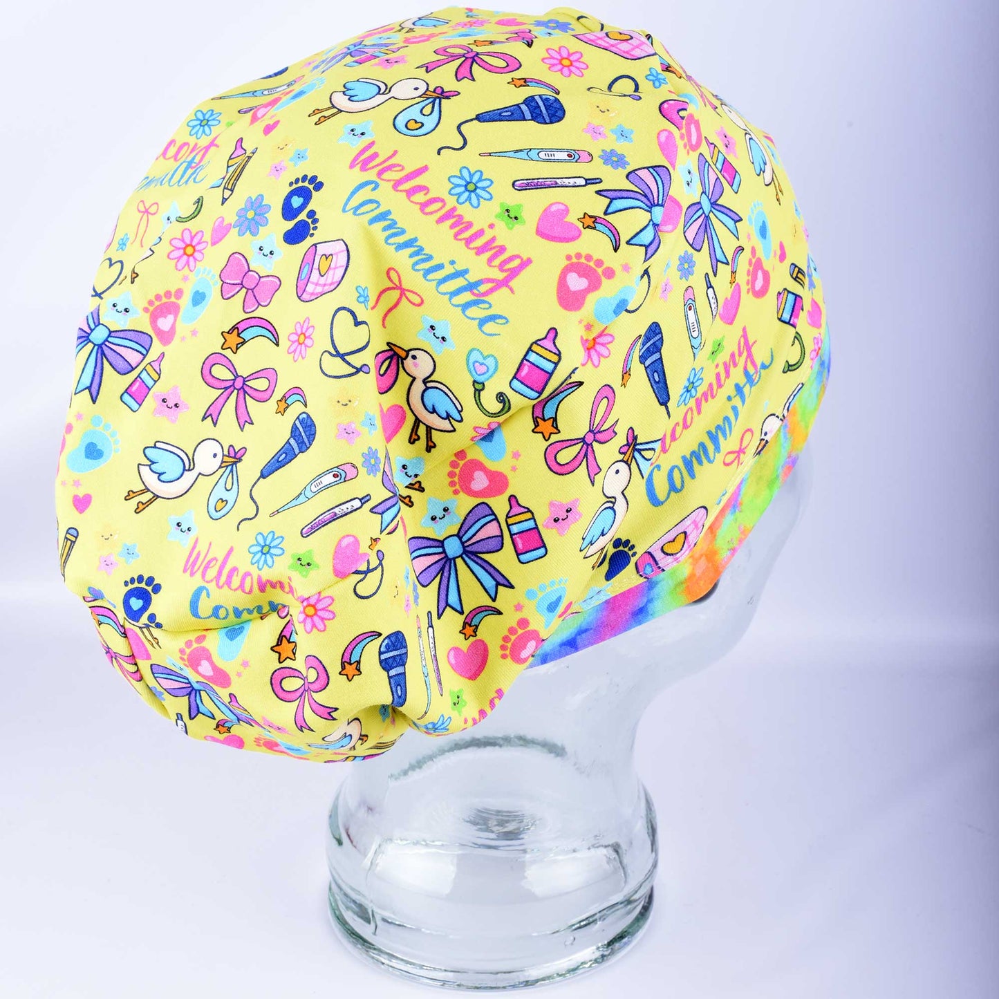 Detailed side view of the adjustable infant-patterned scrub cap on a mannequin, highlighting the seamless design and breathable, stretchy cotton-elastane fabric blend.