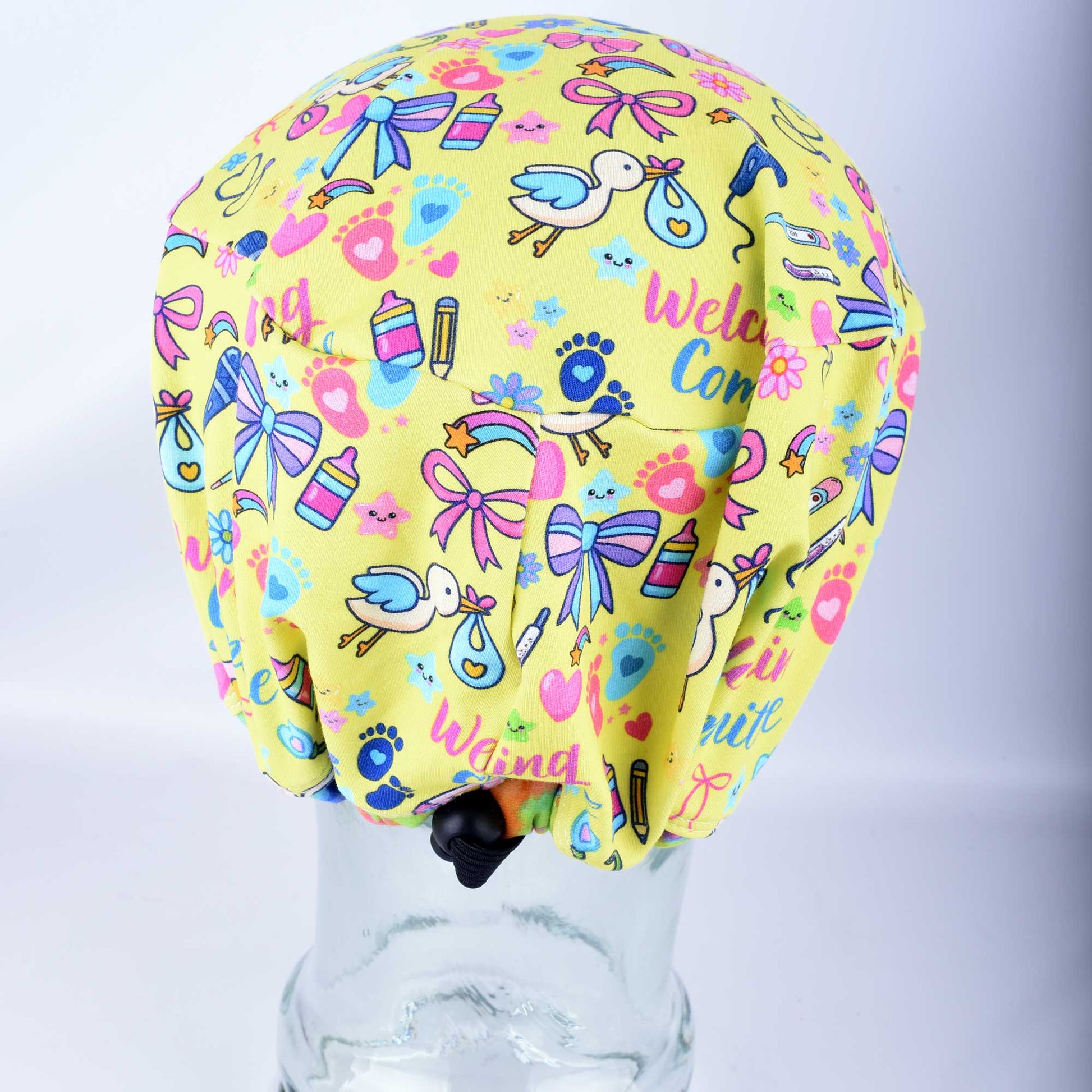 Back view of the Welcoming Committee scrub cap, showing the gathered fabric, encased elastic band, and the adjustable heavy-duty cord lock toggle drawstring for a custom fit.