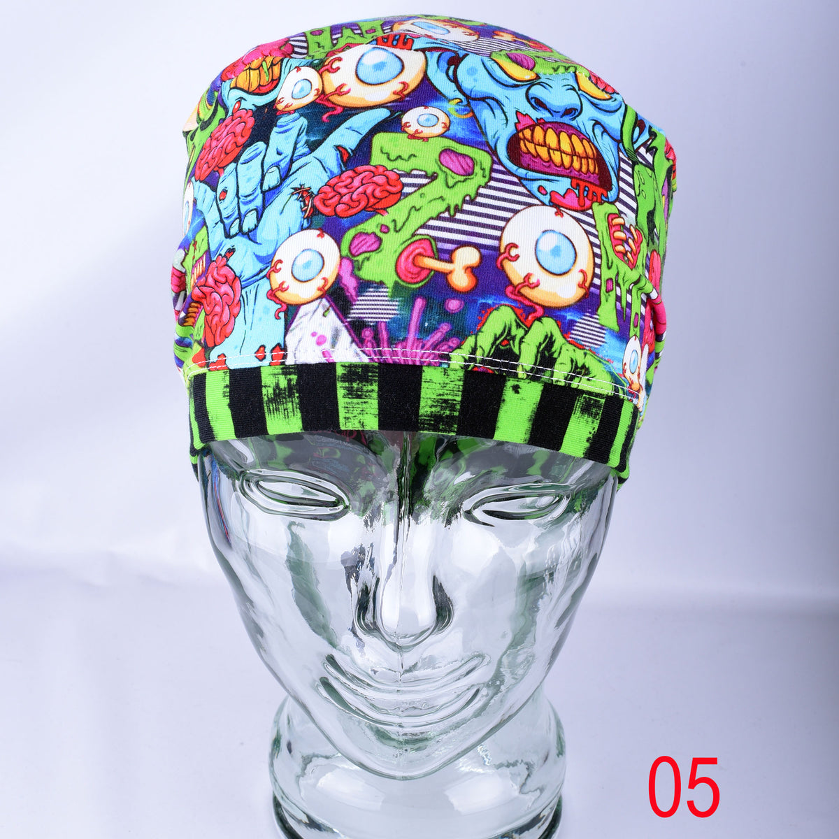 Close-up detail of the stretchy knit cotton-elastane fabric featuring a bright neon zombie and brain graphic pattern.