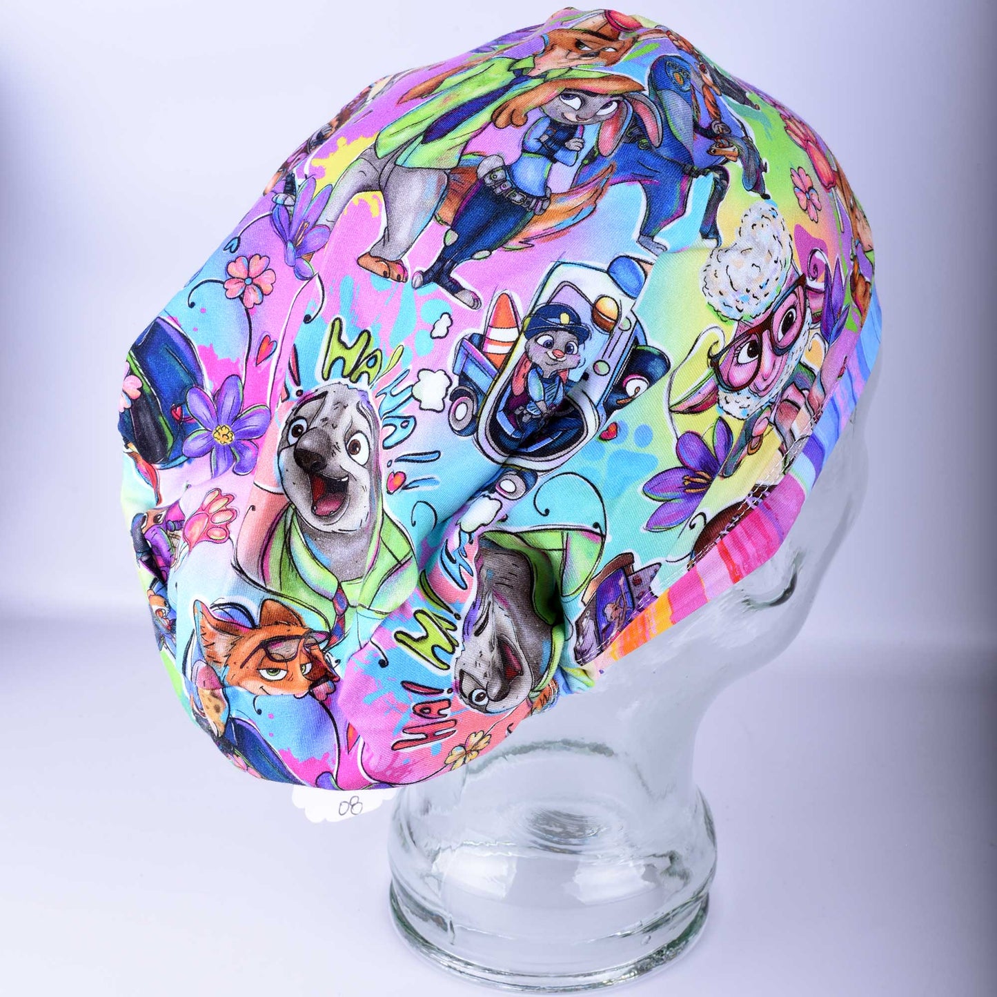 Side view of the Zoo Friends scrub hat showing the stretchy cotton-elastane fabric and the deep, full-coverage fit designed for all hair lengths.