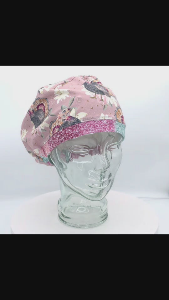 Video preview showing a 360-degree view of the Thanksgiving turkey pattern scrub cap on a clear display head.