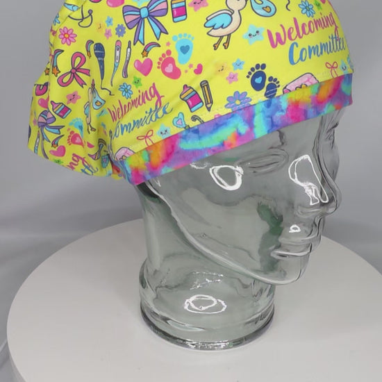Video preview of the adjustable Welcoming Committee scrub cap rotating on a clear mannequin head, demonstrating the 360-degree fit and custom-milled fabric quality.