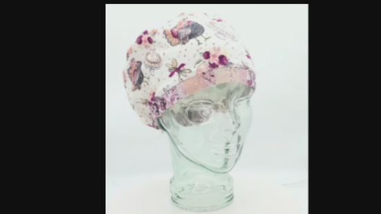 Short video showing a 360-degree view and adjustable fit of a Thanksgiving Turkey Feast themed Euro-style scrub cap on a display model.