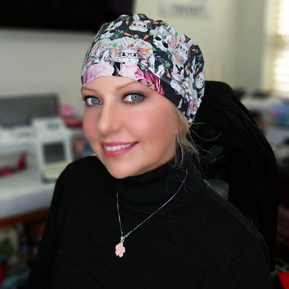 Full coverage medical headwear designed for long shifts, featuring an adjustable toggle and a festive rabbit design worn by a healthcare professional.